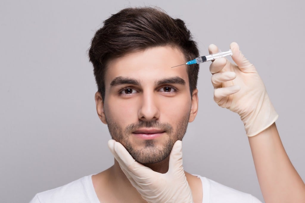 filler injection for male face in beauty clinic picture id1031828904